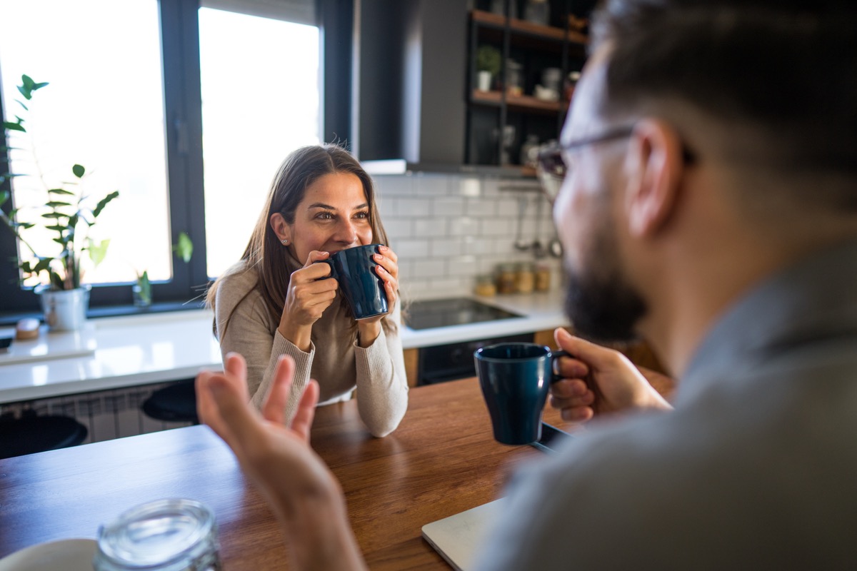 Two people having a conversation over coffee